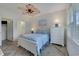 Bedroom featuring coastal decor, a ceiling fan, and natural light from the large windows at 5801 Oyster Catcher Dr. # 1614, North Myrtle Beach, SC 29582