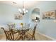 Cozy dining area features a glass-top table, decorative chandelier, and artwork accentuating the space's beachside aesthetic at 5801 Oyster Catcher Dr. # 1614, North Myrtle Beach, SC 29582