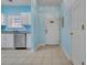 Entryway view featuring a tiled floor, white door and white cabinets with blue walls at 5801 Oyster Catcher Dr. # 1614, North Myrtle Beach, SC 29582