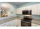 Kitchen featuring white cabinets, granite countertops, and stainless steel appliances at 5801 Oyster Catcher Dr. # 1614, North Myrtle Beach, SC 29582