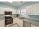 Modern kitchen features granite countertops, stainless steel appliances, and ample cabinet space at 5801 Oyster Catcher Dr. # 1614, North Myrtle Beach, SC 29582