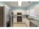 Bright kitchen with stainless steel appliances, granite countertops, and white cabinets for ample storage at 5801 Oyster Catcher Dr. # 1614, North Myrtle Beach, SC 29582