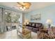 Inviting living room with tile floors, ceiling fan, and sliding glass doors to patio at 5801 Oyster Catcher Dr. # 1614, North Myrtle Beach, SC 29582