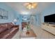 Bright living room features tile floors, a ceiling fan, and views of the dining area and kitchen at 5801 Oyster Catcher Dr. # 1614, North Myrtle Beach, SC 29582