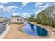 Aerial view of the exterior and pond behind the building with parking on this property at 5801 Oyster Catcher Dr. # 724, North Myrtle Beach, SC 29582