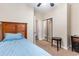Cozy bedroom features a twin bed with blue bedding, carpet floors, and a mirrored sliding door closet at 5801 Oyster Catcher Dr. # 724, North Myrtle Beach, SC 29582