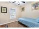 Small bedroom with carpet floor, a ceiling fan and a window overlooking a partial view of the lake at 5801 Oyster Catcher Dr. # 724, North Myrtle Beach, SC 29582