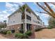 Exterior of a multi-story condominium building with brick and siding and nice landscaping at 5801 Oyster Catcher Dr. # 724, North Myrtle Beach, SC 29582