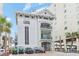 Exterior view of building with private covered balconies, golf carts, and an elevator tower at 5801 Oyster Catcher Dr. # 724, North Myrtle Beach, SC 29582