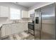 Well-lit kitchen with stainless steel appliances, white cabinetry, and a view to the backyard at 5801 Oyster Catcher Dr. # 724, North Myrtle Beach, SC 29582