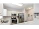 Modern kitchen with stainless steel appliances, white cabinets, and quartz countertops at 5801 Oyster Catcher Dr. # 724, North Myrtle Beach, SC 29582