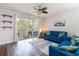 Living room with a blue sofa and a sliding glass door to a screened porch at 5801 Oyster Catcher Dr. # 724, North Myrtle Beach, SC 29582