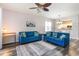 Living room with blue sofas, gray rug, and view to the kitchen at 5801 Oyster Catcher Dr. # 724, North Myrtle Beach, SC 29582