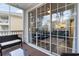 Screened-in patio with comfortable seating, and sliding glass doors into the living room at 5801 Oyster Catcher Dr. # 724, North Myrtle Beach, SC 29582