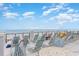 View from the rooftop deck features lounge chairs, tables, and ocean views in the background at 5801 Oyster Catcher Dr. # 724, North Myrtle Beach, SC 29582