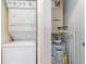 A utility closet featuring a stackable washer/dryer and HVAC unit with a hot water heater at 5801 Oyster Catcher Dr. # 724, North Myrtle Beach, SC 29582