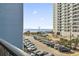 Balcony view of the beach, parking area and neighboring building, showcasing the coastal setting at 5905 S Kings Hwy. # 318B, Myrtle Beach, SC 29575