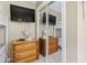 Bedroom closet with wooden dresser, closet mirror and a mounted television at 5905 S Kings Hwy. # 318B, Myrtle Beach, SC 29575