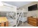 Cozy bedroom with white bunk beds, TV, a ceiling fan, and a wooden dresser at 5905 S Kings Hwy. # 318B, Myrtle Beach, SC 29575