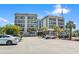 Exterior view of a residential building with palm trees and parking at 5905 S Kings Hwy. # 318B, Myrtle Beach, SC 29575
