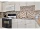 Well-equipped kitchen featuring modern appliances and granite countertops for a functional and stylish space at 5905 S Kings Hwy. # 318B, Myrtle Beach, SC 29575