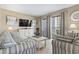 Living room showcasing couches, a cabinet with decorations, a table, and a balcony at 5905 S Kings Hwy. # 318B, Myrtle Beach, SC 29575
