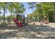 A vibrant playground with slides, swings, and climbing structures, surrounded by trees at 5905 S Kings Hwy. # 318B, Myrtle Beach, SC 29575