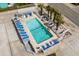 Aerial view of pool featuring lounge chairs, palm trees, and white picket fence at 625 N Waccamaw Dr. # 102, Murrells Inlet, SC 29576