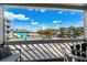 Balcony view overlooking a street with palm trees and a swimming pool at 625 N Waccamaw Dr. # 102, Murrells Inlet, SC 29576