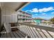 Inviting balcony view with chair overlooking the community pool and beautiful sky at 625 N Waccamaw Dr. # 102, Murrells Inlet, SC 29576