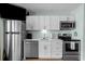 Modern kitchen features stainless steel appliances, white cabinets, and sleek countertops at 625 N Waccamaw Dr. # 102, Murrells Inlet, SC 29576