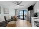 Cozy living room with sliding glass doors leading to a private balcony at 625 N Waccamaw Dr. # 102, Murrells Inlet, SC 29576