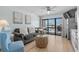 Cozy living room with a plush sofa, a glass coffee table, and a dining area with a scenic view at 625 N Waccamaw Dr. # 102, Murrells Inlet, SC 29576