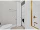Compact bathroom featuring a toilet, stackable washer/dryer unit and shower with gold trim at 670 2Nd Ave. N, North Myrtle Beach, SC 29582