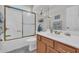 Bright bathroom with a bathtub, and a wood vanity featuring a white sink at 670 2Nd Ave. N, North Myrtle Beach, SC 29582