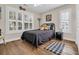 Cozy bedroom with wood floors, natural light, queen size bed, and tropical themed decor at 670 2Nd Ave. N, North Myrtle Beach, SC 29582