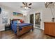 Comfortable bedroom with a wood frame bed, colorful pillows, and sliding glass door at 670 2Nd Ave. N, North Myrtle Beach, SC 29582