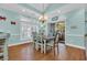 Inviting dining area with stylish table, chairs, and sliding doors to screened porch, filled with natural light at 670 2Nd Ave. N, North Myrtle Beach, SC 29582