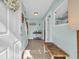 Inviting entryway featuring neutral walls, tile flooring, a wooden bench, and staircase at 670 2Nd Ave. N, North Myrtle Beach, SC 29582