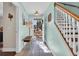 Bright entryway with a wooden bench and staircase, leading to the upper level of the home at 670 2Nd Ave. N, North Myrtle Beach, SC 29582