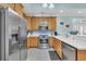 Modern kitchen with stainless steel appliances, light wood cabinetry, and breakfast bar overlooking living area at 670 2Nd Ave. N, North Myrtle Beach, SC 29582