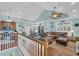 Open-concept living space with vaulted ceilings, stylish furnishings, hardwood floors, and seamless flow to kitchen and dining areas at 670 2Nd Ave. N, North Myrtle Beach, SC 29582