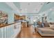 Open-concept design connecting the living room, kitchen, and dining area, featuring hardwood floors and soft blue walls at 670 2Nd Ave. N, North Myrtle Beach, SC 29582
