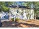 Rear exterior of the home showing the siding, windows, and small yard with natural landscape at 670 2Nd Ave. N, North Myrtle Beach, SC 29582