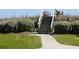 Convenient beach access via stairs surrounded by lush landscaping, perfect for coastal living at 671 Norris Dr., Pawleys Island, SC 29585