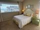 Bright bedroom featuring queen bed, a side table with decor, carpeted floors, and a sunny window view at 671 Norris Dr., Pawleys Island, SC 29585