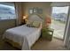 Bedroom featuring queen bed, a side table with decor, carpeted floors, and a bright window view at 671 Norris Dr., Pawleys Island, SC 29585