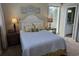 Inviting bedroom featuring a queen bed, beach themed artwork and an ensuite bathroom at 671 Norris Dr., Pawleys Island, SC 29585
