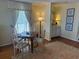 Dining area with seating for four, with view of bar and seaside art at 671 Norris Dr., Pawleys Island, SC 29585