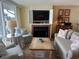 Stylish living room showcasing a fireplace and ocean views from the nearby balcony at 671 Norris Dr., Pawleys Island, SC 29585